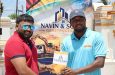 Ganeshram Deokissoon (left) of Navin and Sons Construction hands over the sponsorship to Shamar Gray of One Guyana T10 Tapeball Blast