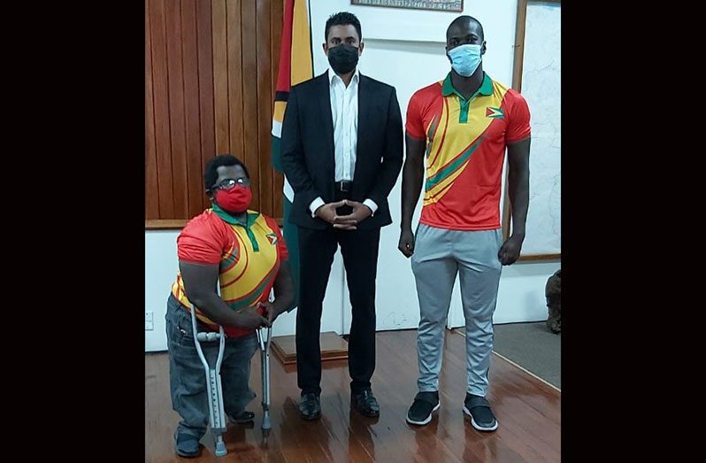 Coach Jamie Skeete (first from left) and Andrew Fowler made a courtesy call on Minister of Culture, Youth and Sport, Charles Ramson Jr, prior to their departure to Argentina.