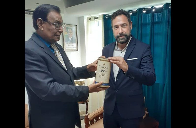 Vice-President of the Gastro Group, Ladislav Starka (right), is seen receiving a bottle of the El Dorado 21-Year-old rum from Ambassador Majeed