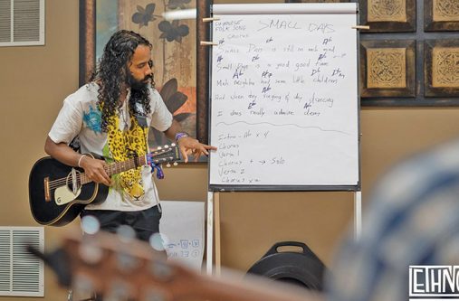 Gavin Mendonca teaches the group the lyrics for Guyanese folk song, Small Days