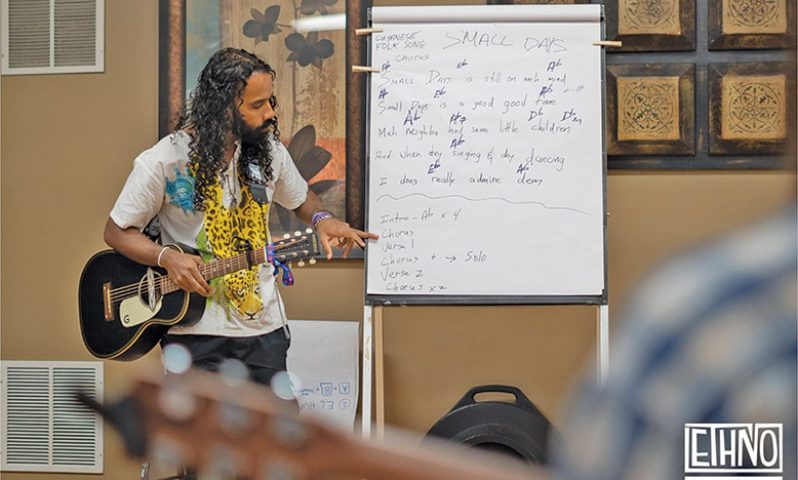 Gavin Mendonca teaches the group the lyrics for Guyanese folk song, Small Days