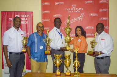 Gavin Todd presents the first-place trophy to Anasha Ally while Chet Bowling, Ian Charles and Troy Peters display some of the other trophies that will be  up for grabs