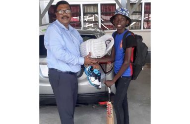 Delounce Fredericks, left, receives his gear from Surindradat Beharry.