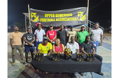 Seated from left are UDFA’s General Secretary Kellon Josiah, PRO Reycia Nedd, President Wainwright Bethune abd Banks DIH representative Omari Gordon with some club representatives standing behind