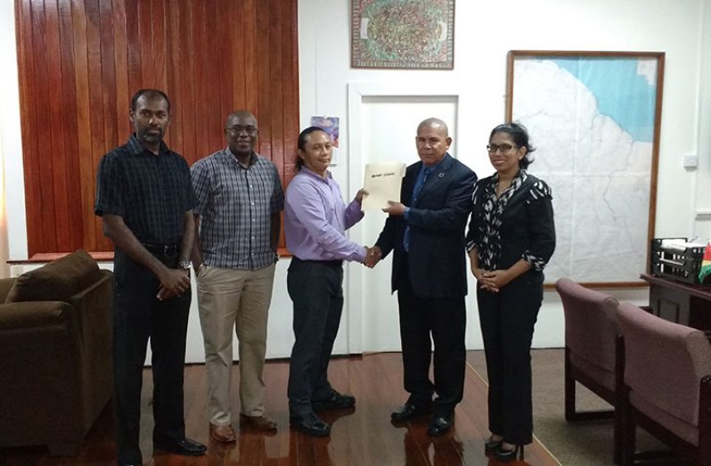 Archery Guyana’s Chair, Mr. Nicholas Hing handing over the National Development Plan to Minister Dr. George Norton. Looking on are Directors, Mrs. Vidushi Persaud-McKinnon, Mr. Steve Ninvalle and Mr. Ryan McKinnon.