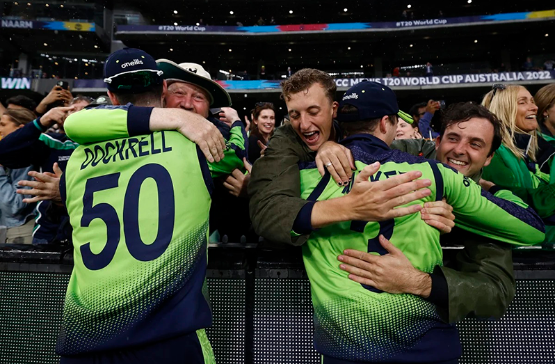 George Dockrell and Lorcan Tucker get big hugs from the crowd. (ICC via Getty Images)