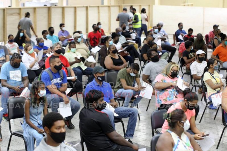 People wait to get vaccinated on Sunday (Trinidad and Tobago Newsday photo)