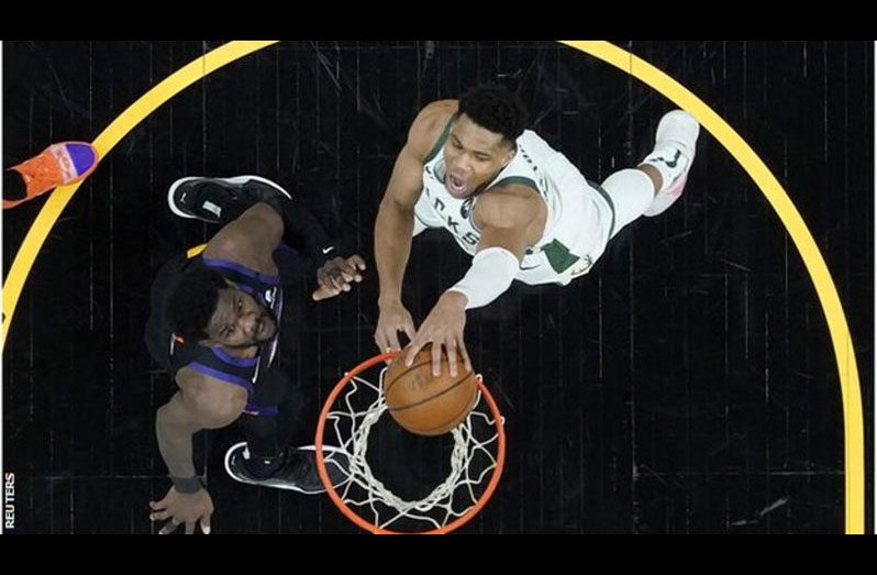 Bucks' Giannis Antetokounmpo (right) returned from a knee injury to score 20 points in his first game of the NBA Finals.