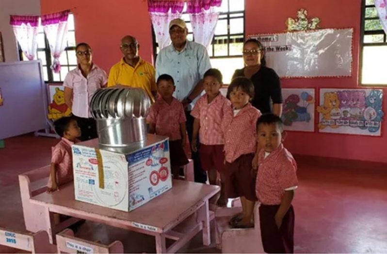 Minister Trotman along FCPF Project Coordinator, Clayton Hall, among students and teachers of the nursery school (DPI photo)