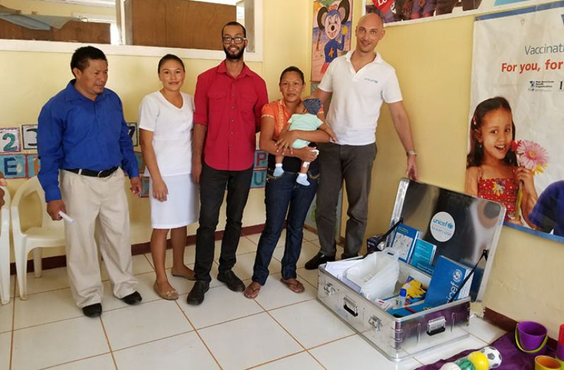Paolo Marchi (extreme right) and Dr Stephan Gravesande (centre) with regional officials after the handing over of items for the Early Childhood programme