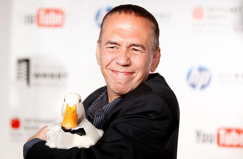 Comedian Gilbert Gottfried arrives with a duck at the Webby Awards in New York June 14, 2010. REUTERS/Lucas Jackson