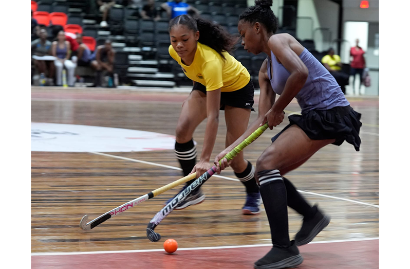 Saints mid-fielder Clayza Bobb trying to evade the challenge of Hikers Trinity Greaves in their girls' U-21 clash