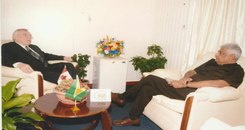 Canadian High Commissioner Mr. Pierre Giroux and GECOM’s Dr Steve Surujbally in talks Tuesday at the latter’s upper High Street, Kingston office
