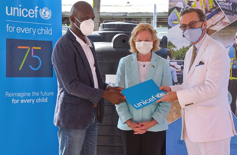 UNICEF Representative Nicolas Pron formally handing over the water tanks on Friday to CDC Director-General, Lieutenant Colonel Kester Craig in the presence of US Ambassador to Guyana, Sarah-Ann Lynch