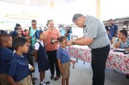 Parliamentary Representative for Region One, Minister of Housing and Water, Collin Croal places a new pair of spectacles on a student as part of government’s ongoing efforts to enhance healthcare access in remote areas