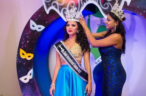 Cynthia Dookie being crowned by her predecessor, Poonam Singh