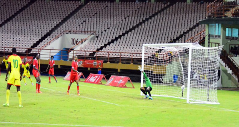 Suriname goalkeeper dives too late as this Jackie Chan’s shot has already pierced him.
