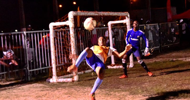In this Adrian Narine photo, an attacker attempts the famous bicycle kick during last evening’s final round of the Petra/Ministry of Health/Stop Gender-Based Violence Football tournament.