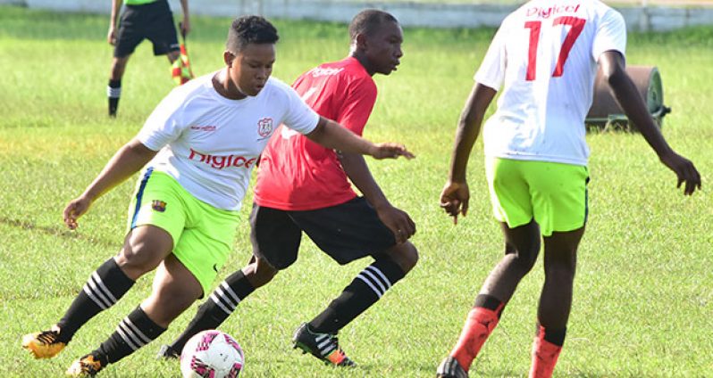A Bishops’ High School midfielder gets ready to send a through ball to his teammate during yesterday’s Digicel National Schools Football Championships at the Guyana Defence Force ground. Bishops’ High beat Tutorial High 3-1. (Adrian Narine photo)