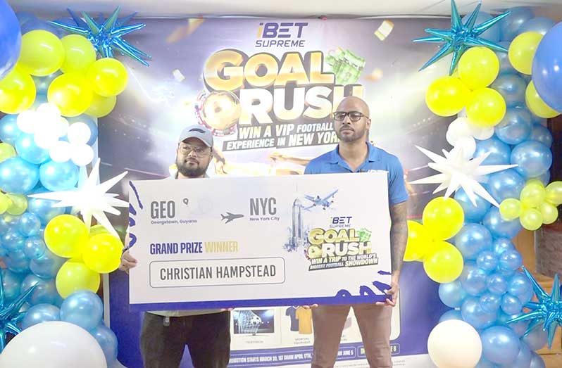 I-Bet Supreme country manager Dennis Scantlebury (right) handing over the cheque to winner, Christian Hampstead