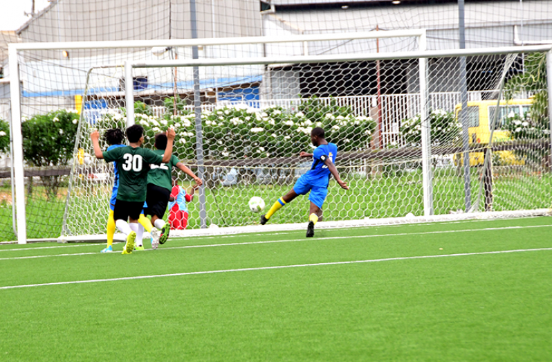 Captain Adica Ash of the Shiva Hindu Boys College scores one of his three goals against Annai in the KFC goodwill football series (Adrian Narine Photo)