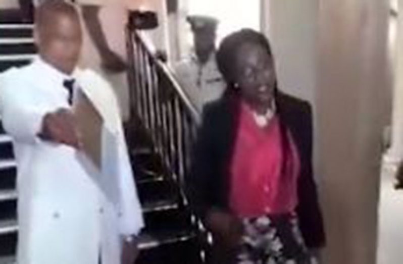 The female ‘singer’ as she was escorted down the stairs of Parliament on Thursday