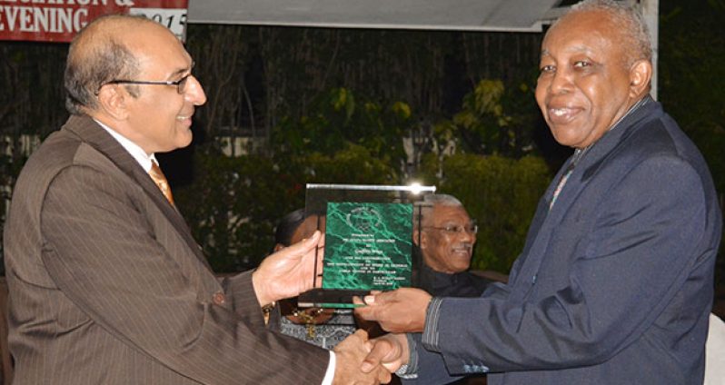 Editor of the Guyana Chronicle Godfrey Wray receives his award from GOA president K.Juman Yassin