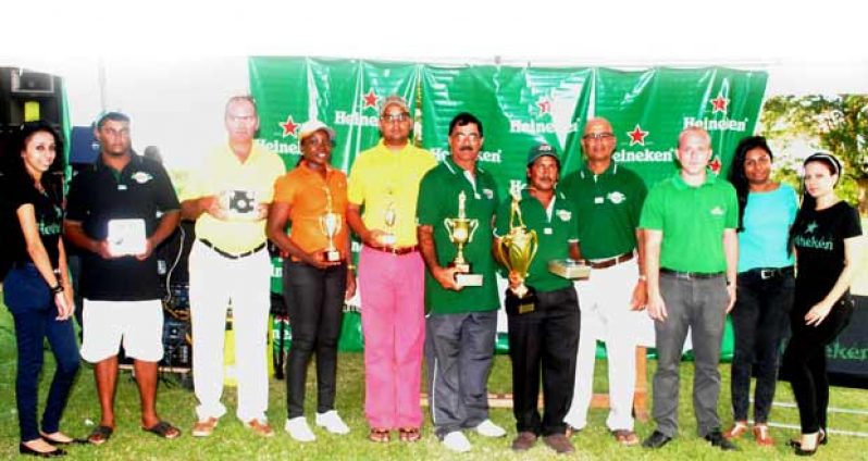Mike Mangal (fifth from left) is in company with the other top finishers and organisers of yesterday’s Heineken Cup Golf tournament.