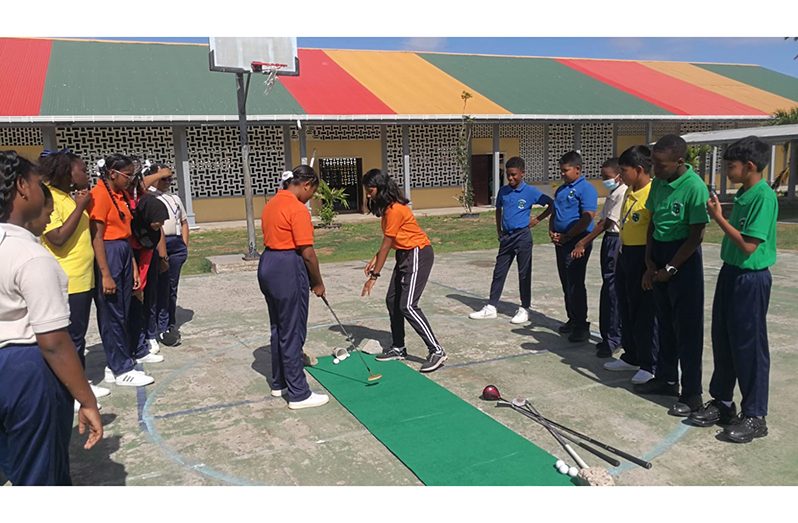 Some of the students participating in the golf course