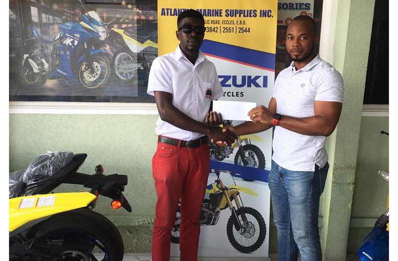 In Photo Mr, Lancelot Gordon, Operation's Manager of AMSI, present his company support to Petra's representative Mr. Mark Alleyne.