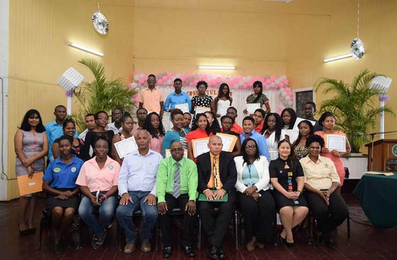 Minister of Social Cohesion, Dr. George Norton (fourth right);Director of  Youth,  Melissa Carmichael (third right); Senior Economic Empowerment Officer, Samuel Saul (fourth left); Acting CEO of GSA, Dr. Dexter Allen (third left) with graduates (Jameel Mohamed photo)