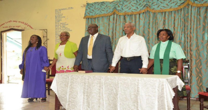 President David Granger stands with Pastor Phillip Campbell (at his right) and elders of the church during the praise and worship session at the Albion Chapel Congregational Church at Fyrish, Corentyne