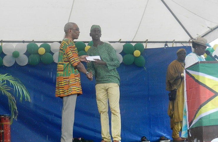 President Granger presents a cheque to one of the Community Grounds Enhancement recipients.