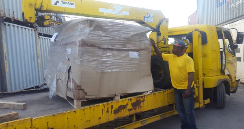 The equipment being unloaded from the wharf onto a truck destined for the National Gymnasium.