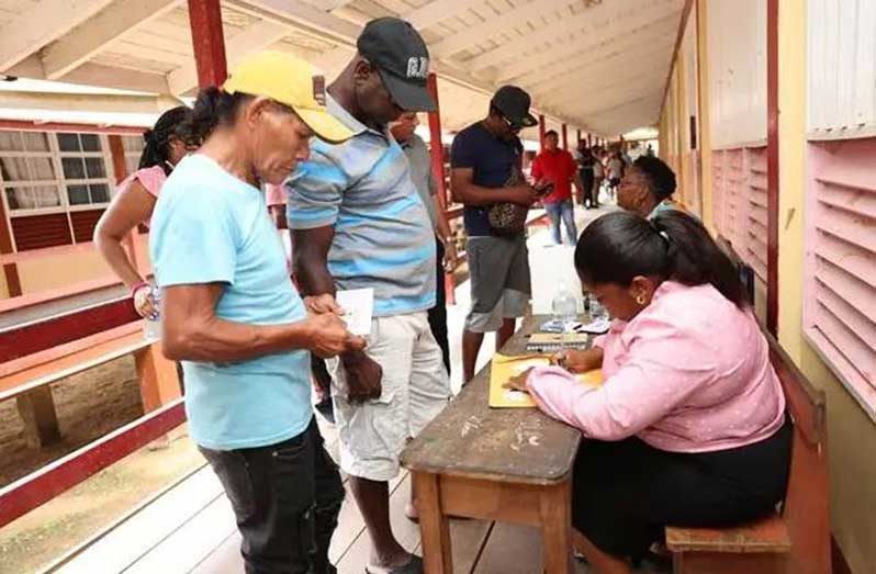 A beneficiary collects his cash grant in Region One