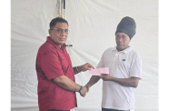 Minister of Agriculture Zulfikar Mustapha presenting a cheque to a fisherman