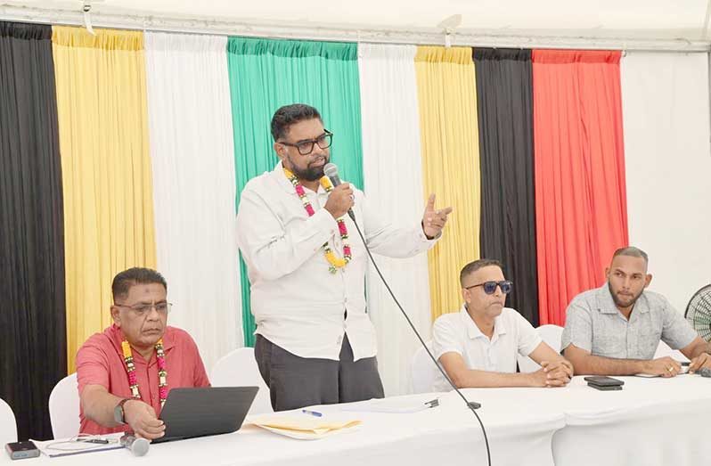 President Dr Irfaan Ali engages rice farmers during the cash grant distribution exercise at Anna Regina on Saturday