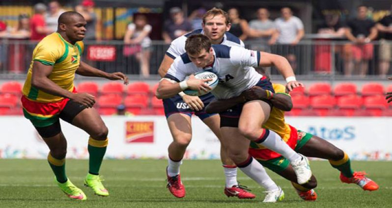 Too strong! Guyana’s captain Richard Staglon (on the tackle) and Dwayne Schroeder in action against the USA at the 2015 Pan Am Games in Canada.