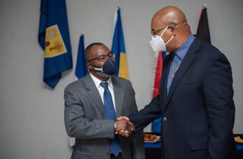 Public Works Minister, Bishop Juan Edghill greets Chairman of Inter-Caribbean Airways, Lyndon Gardiner (DPI photo)