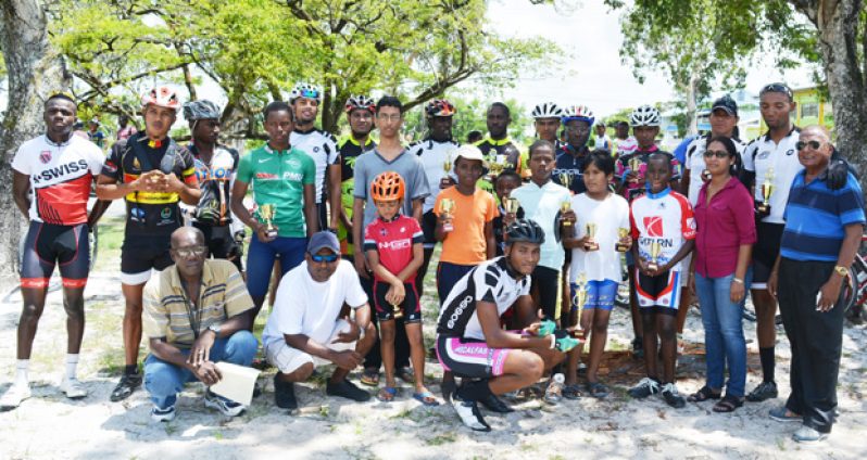 Prize winners of the various categories of yesterday’s Universal Auto Sales and Spares 11-race cycle programme strike a pose with Zayd Baksh (sixth left) son of programme sponsor Shameer Baksh (photo by Ivan Bentham).
