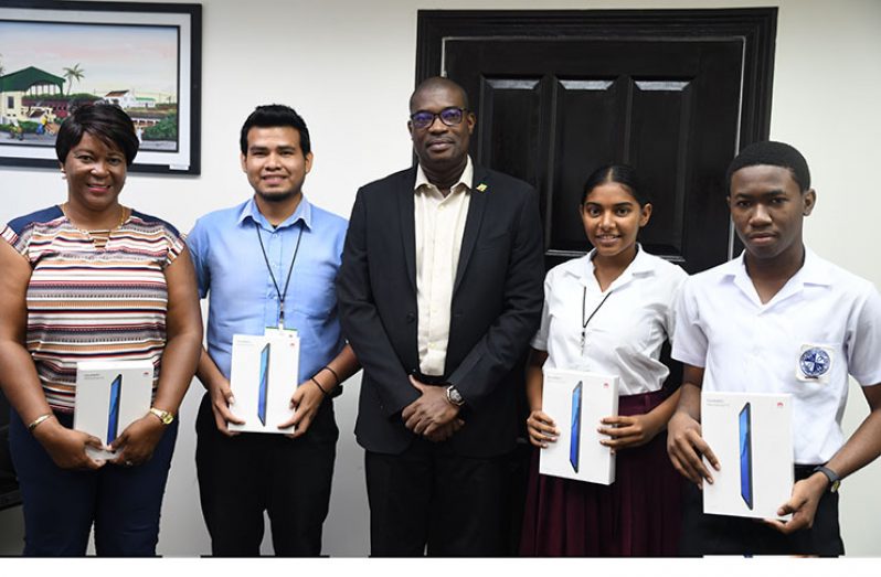 From left: CORE Group Project Coordinator, Charlene Garraway; GTI student, Dishon John; Minister of Public Infrastructure, David Patterson, Amisha Deonarine and Ethan Seymore