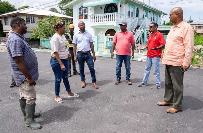The Minister of Public Works, Bishop Juan Edghill, government officials, and residents on one of the upgraded roads in Grove, East Bank of Demerara.