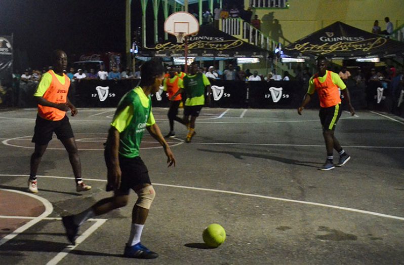 Action on Friday night between Police (orange bib) and Jones Avenue at the Bartica Community Centre tarmac.