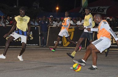 Part of Tuesday night’s action in this year’s Guinness ‘Greatest of De Streets’ tournament between Albouystown ‘A’ (orange bib) and Durban Street, which the former won 2-0