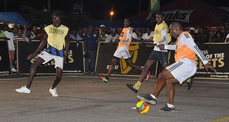 Part of Tuesday night’s action in this year’s Guinness ‘Greatest of De Streets’ tournament between Albouystown ‘A’ (orange bib) and Durban Street, which the former won 2-0