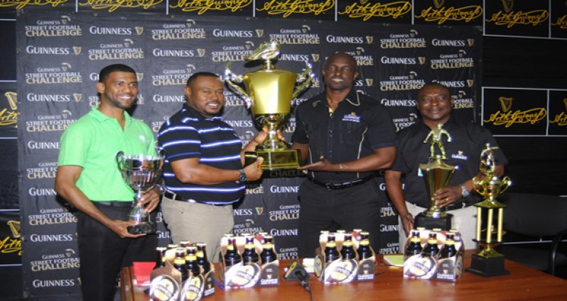 Guinness Brand Manager Lee Baptiste (2nd right) displays the Guinness Greatest of the Street Georgetown Trophy with Petra Director Troy Mendonca and they are flanked by Banks DIH PRO Troy Peters (right) and Rainforest Waters Brand Manager Errol Nelson (left).
