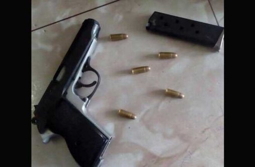 The gun and ammo which were found in the farmer's house.