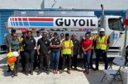 General Manager, Molly Hassan (fourth from left) along with staff in front of one of the new freightliner trucks