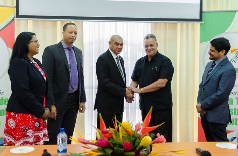 Minister of Business, Haimraj Rajkumar, greeting PSC Chairman, Captain Gerry Gouveia, shortly after the launch of GuyTIE 2020 at the Arthur Chung Conference Centre. Looking on, from left, are:  GuyTIE Coordinator, Tameca Sukdeo-Singh; Chief Executive Officer of Go-INVEST, Owen Verwey; and Caribbean Export’s Damie Sinanan (Photo by Delano Williams)