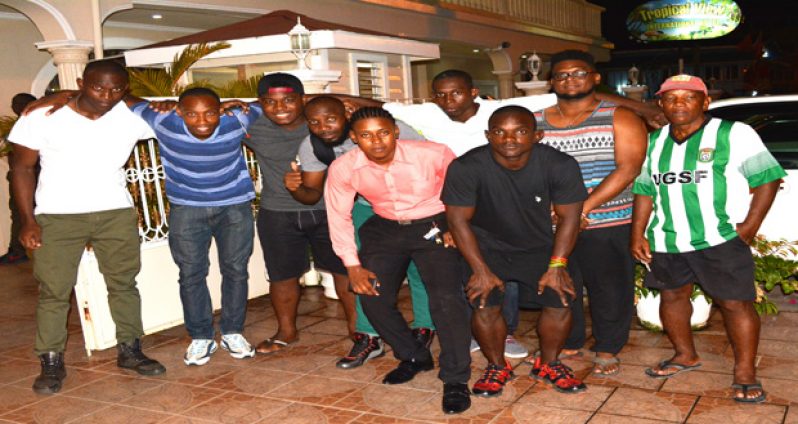 Captain Richard Staglon (Third from right) stands with some of the members of the upbeat Green machine and National Coach Lawrence Adonis (extreme right) prior to checking in at the tropical view hotel last evening (Ivan Bentham photo)